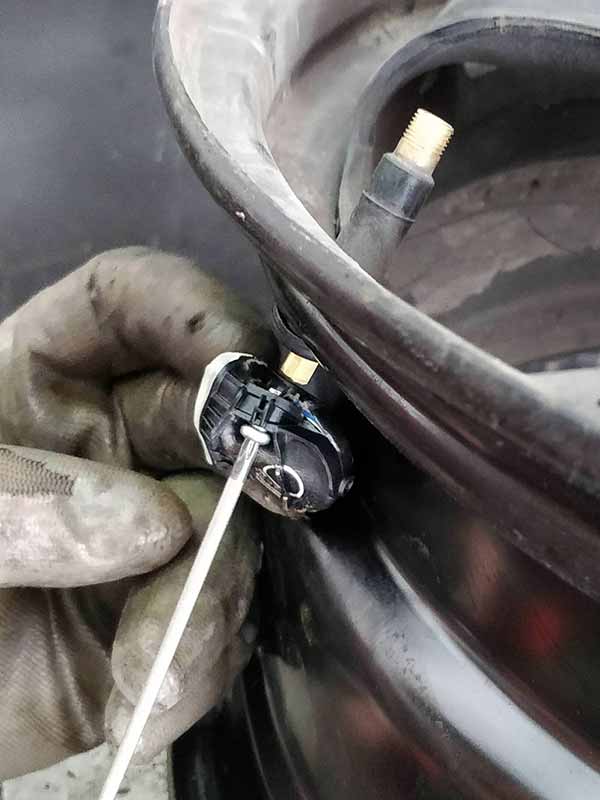 Damaged TPMS Sensor Being Removed